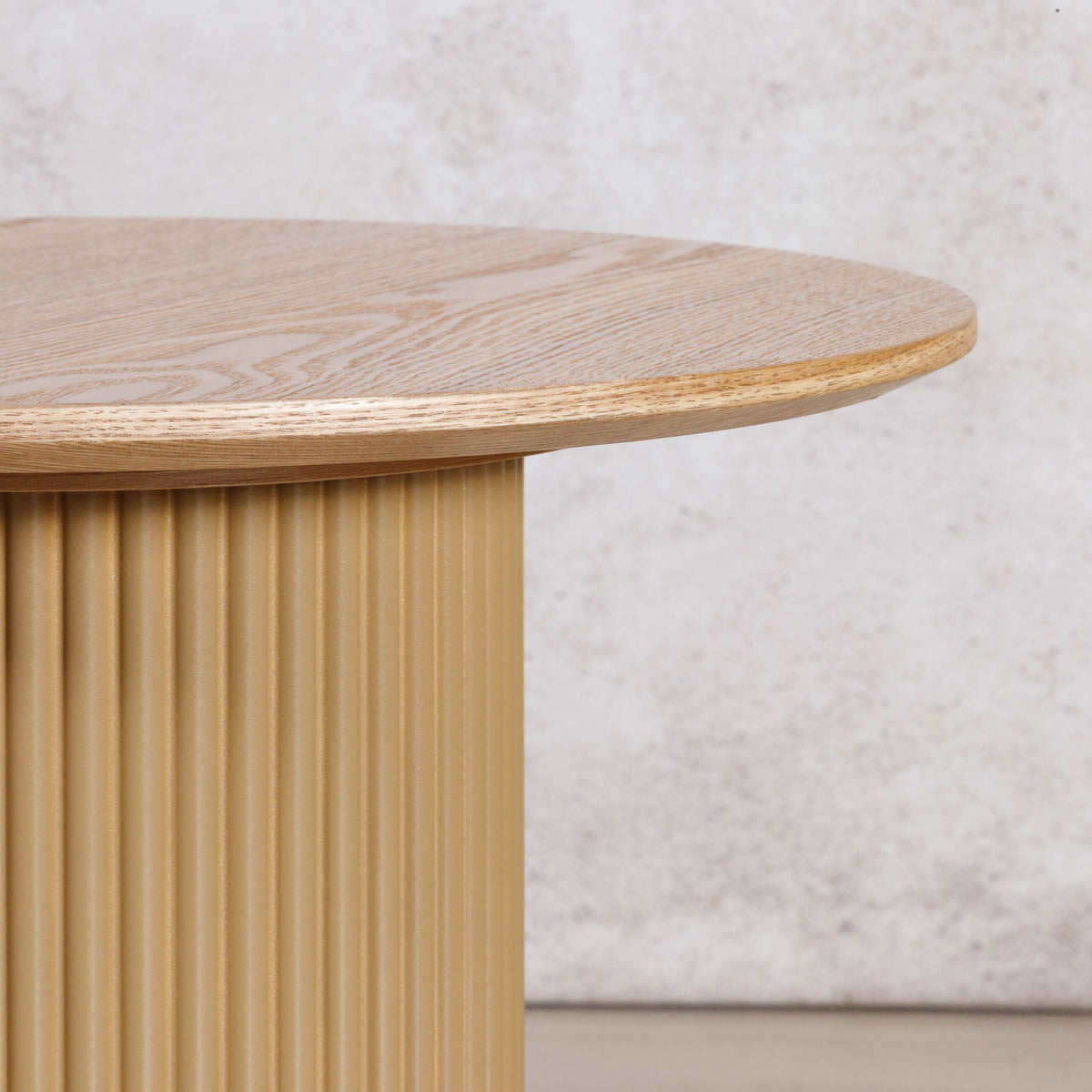 Close-up of the Gallery Everyday Sybil Side Table in Natural, showing the round oak tabletop, natural wood grain, and fluted pedestal base.