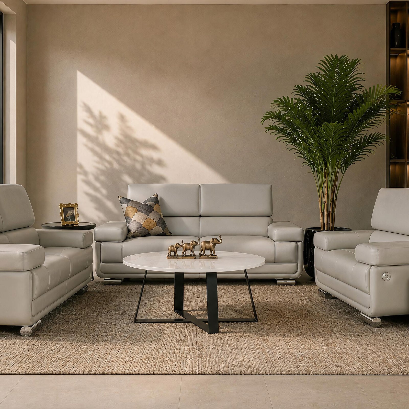 Leather Gallery Tobago 3+2+1 Leather Lounge Suite in Grey, styled with matching leather seating, a round coffee table, and neutral décor in a modern living room.
