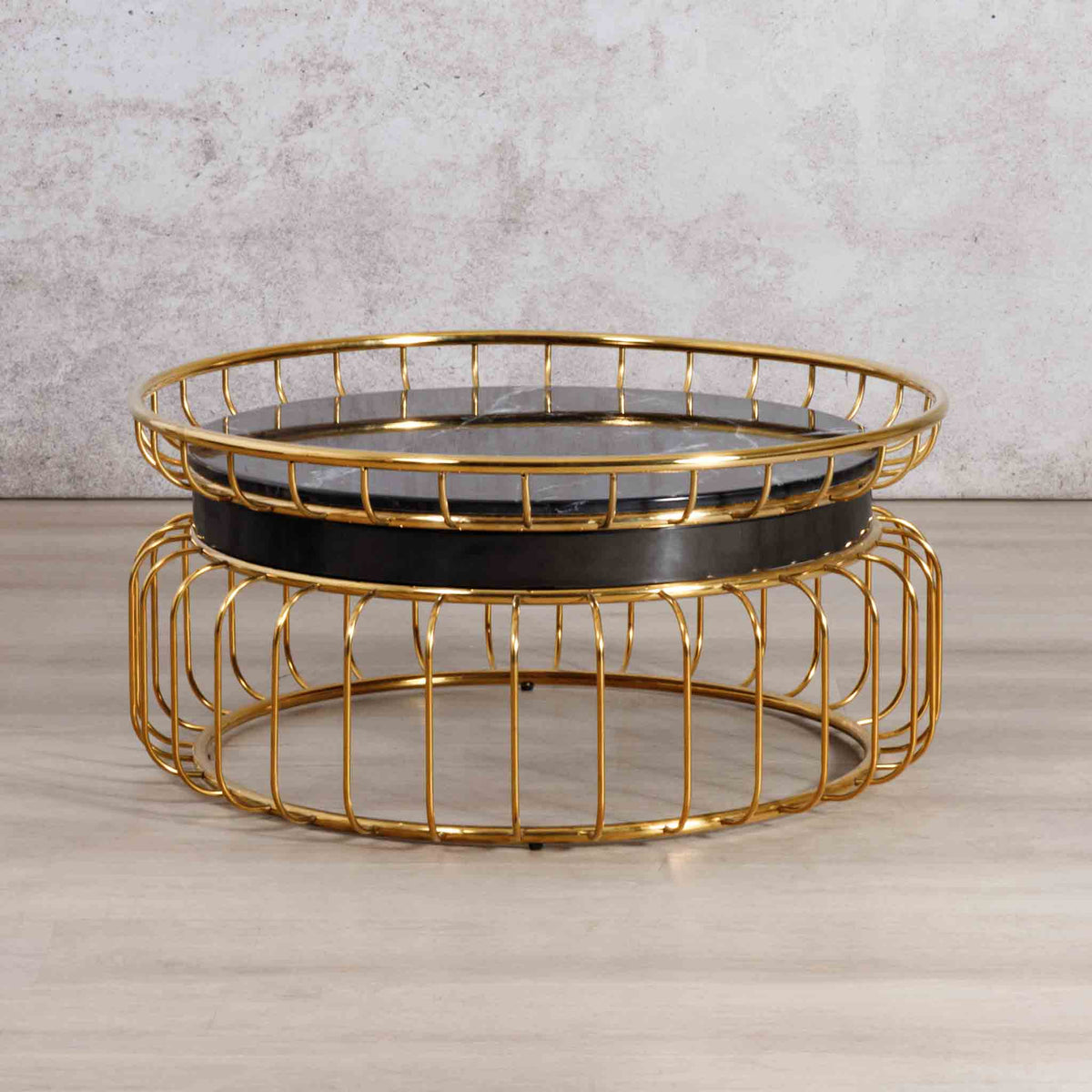 Leather Gallery Eve Coffee Table, featuring a black stone top and gold wire cage base in a nesting design.
