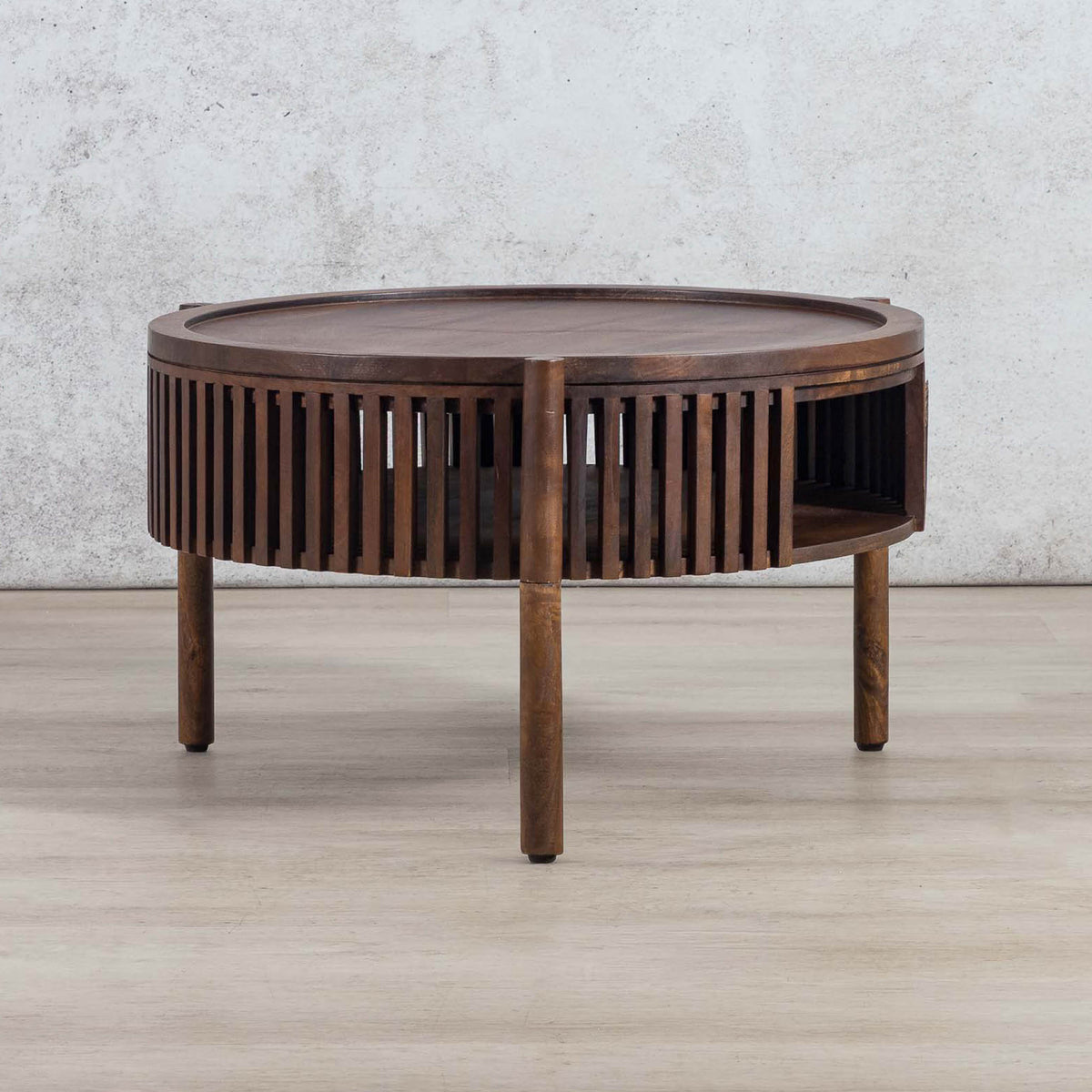 Full view of a round Cassis coffee table with a slatted frame and open shelf, a top choice for those searching for a coffee table for their lounge.