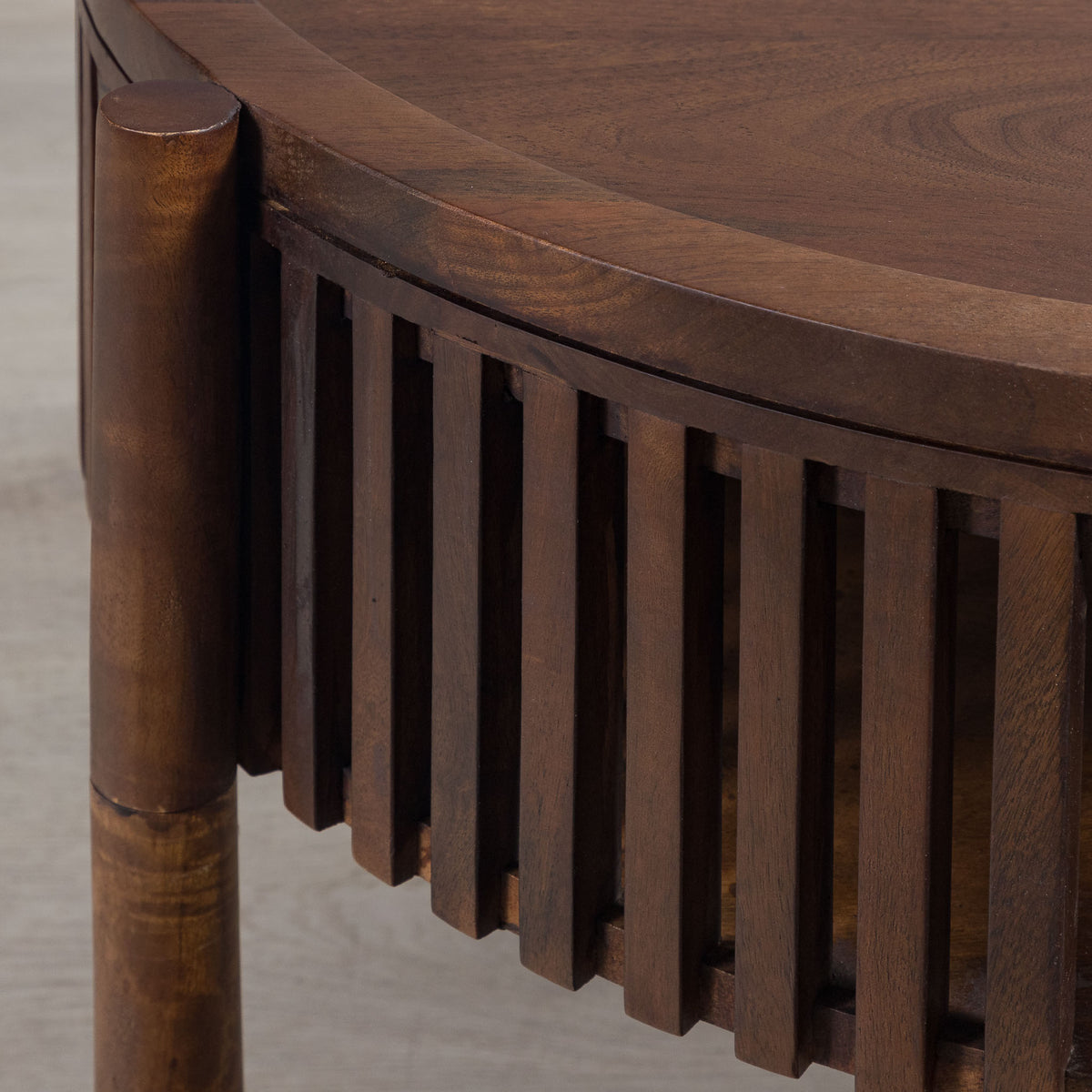 Detailed view of the natural wood grain and slatted base of the Cassis round coffee table, highlighting the craftsmanship and material.