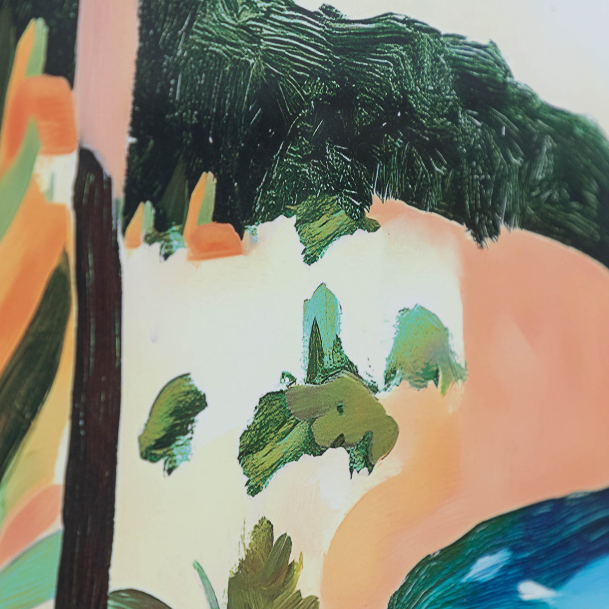 Between Cliff & Sea - Kia Artwork by Leather Gallery featuring a tropical coastline, turquoise ocean, lush green trees and a natural wood-toned frame.