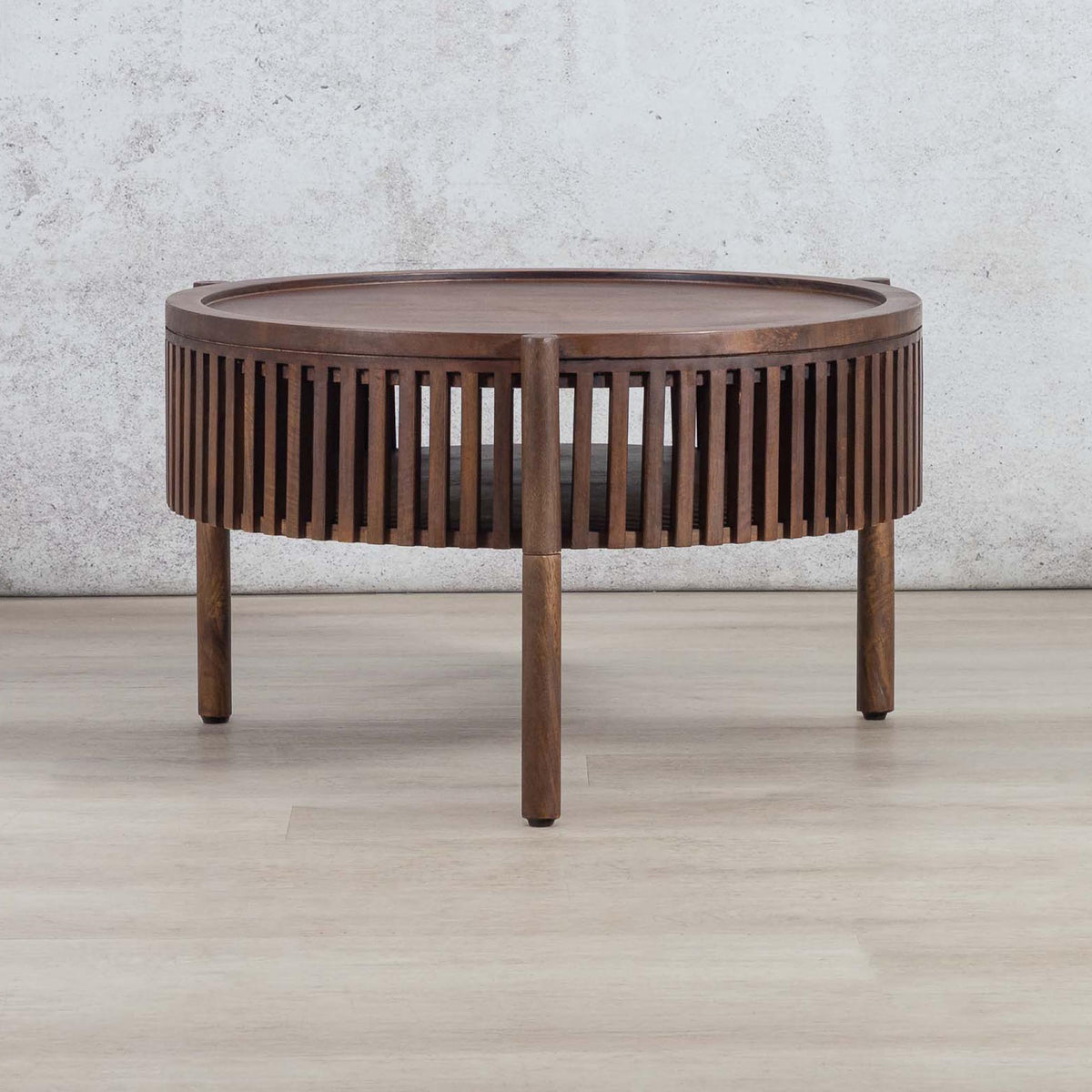 Full view of a round Cassis coffee table with a slatted frame and open shelf, a top choice for those searching for a coffee table for their lounge.