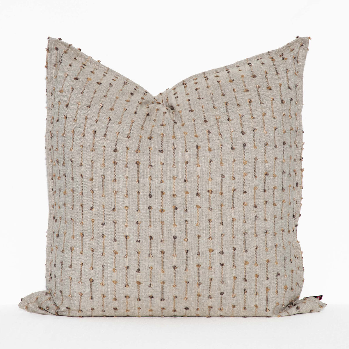 Leather Gallery Veyra Riverstone Cushion, featuring a soft neutral woven finish with delicate brown and golden stitched detailing.