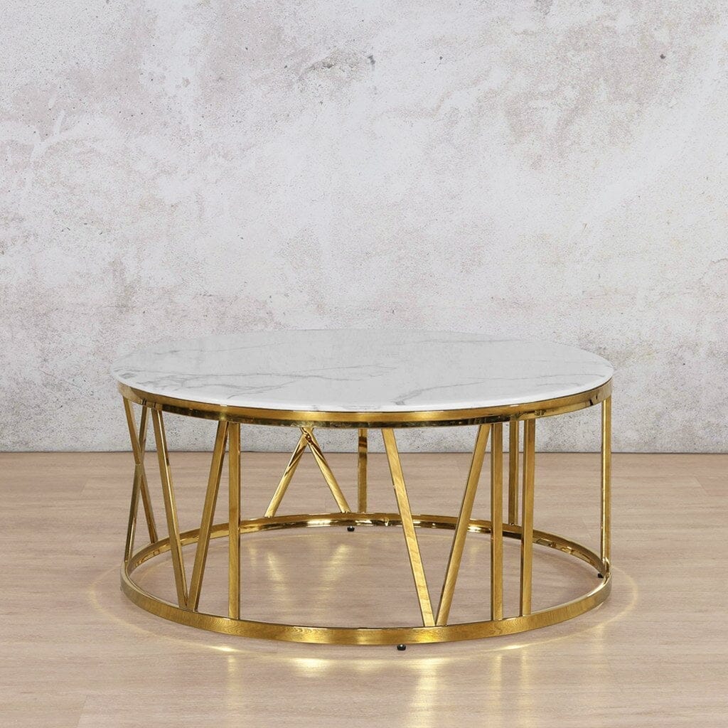 A full view of the Zoya Coffee Table showcasing its white marble-look top and gold geometric base, perfectly suited as a centrepiece for a stylish living room.