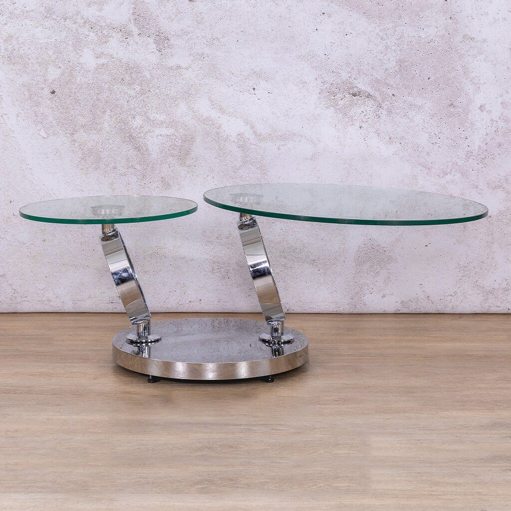 Enhance your living room with the Futuristic Swivel Coffee Table, available in clear glass with silver stainless steel. The adjustable swivel top and spacious dual surfaces make this coffee table both stylish and practical.